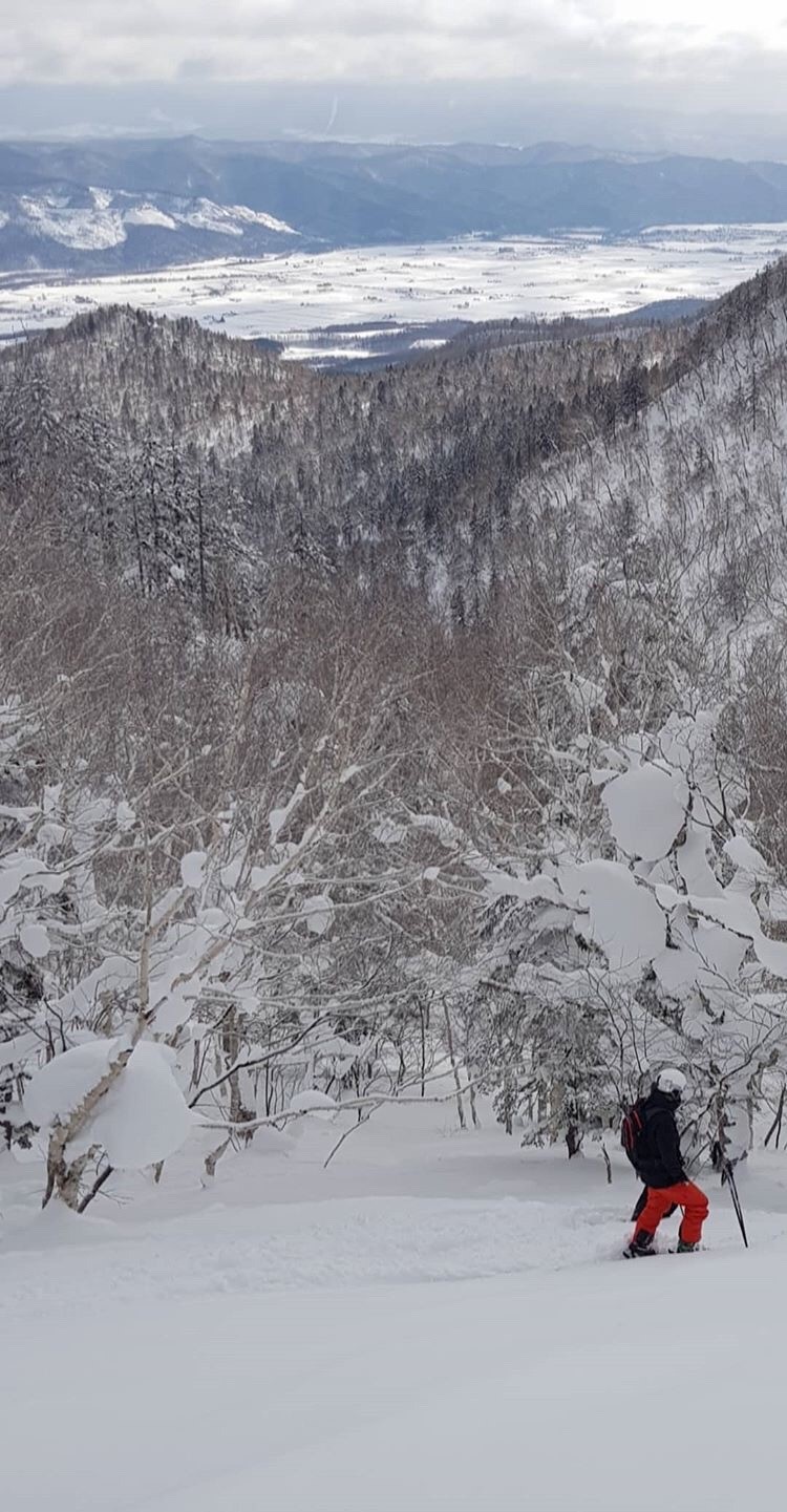 Daisetsuzan Kurodake – Sounkyo in Japan - a person skiing down a snowy mountain.