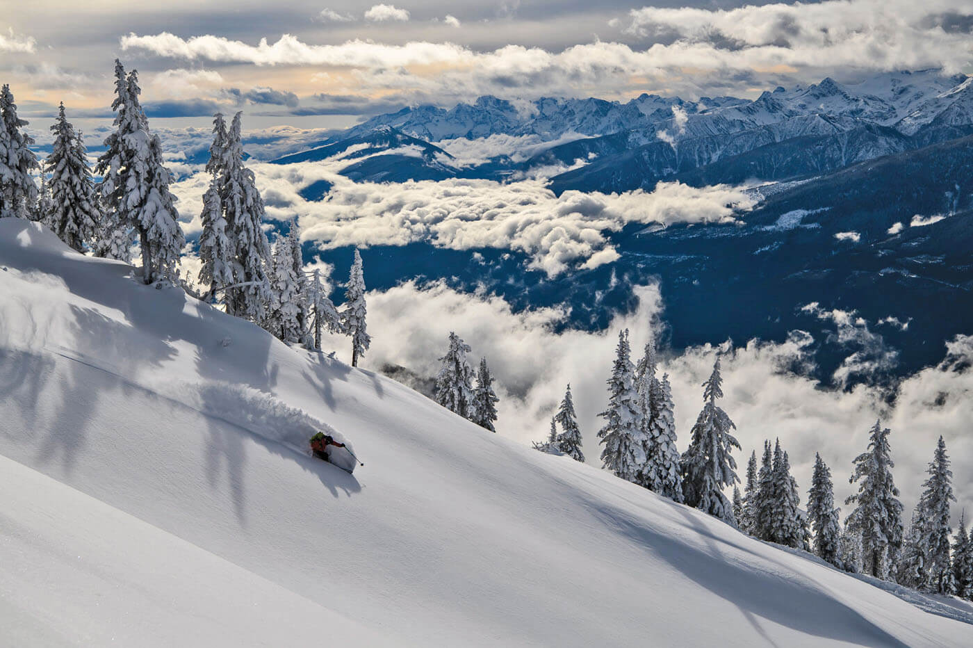 Revelstoke Mountain Resort in Canada - a person skiing down a snow covered mountain.