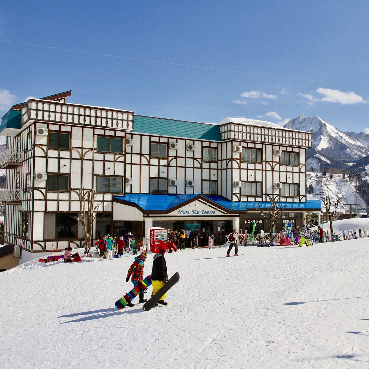 Kaneyama in Japan - a group of people riding ski boards down a snow covered slope.