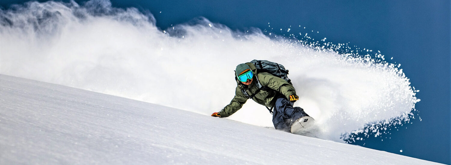 Akita Hachimantai in Japan - a person snowboardinging down a snowy slope.