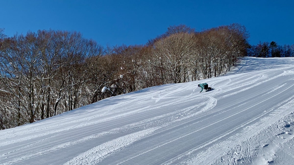 Akita Hachimantai in Japan - a person is skiing down a snowy hill.
