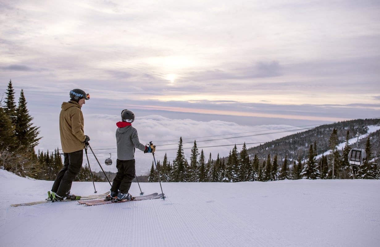 Haute Gaspésie in Canada - two people standing on top of a snow covered mountain.