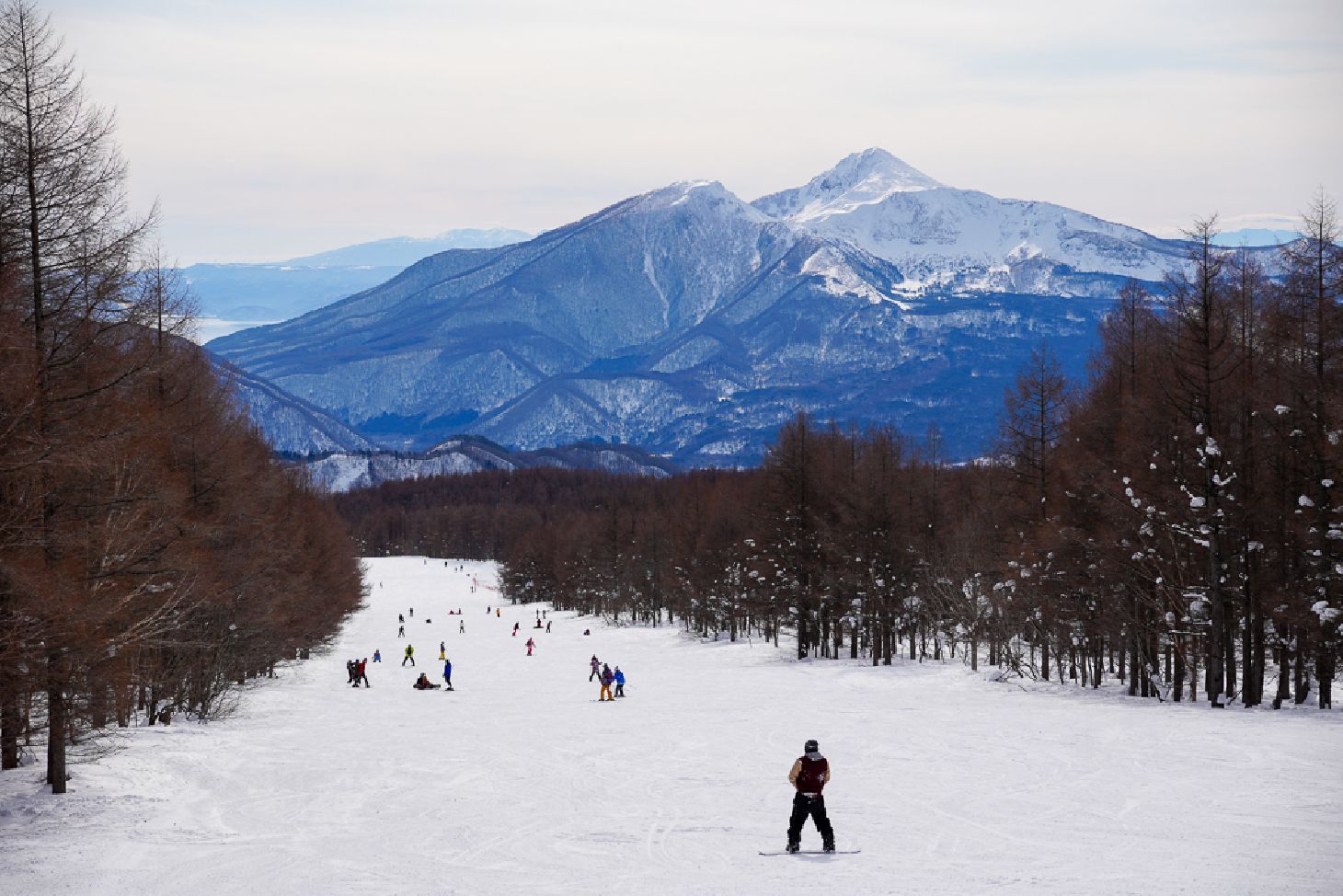 Hinoemata in Japan - a group of people skiing down a snowy slope.