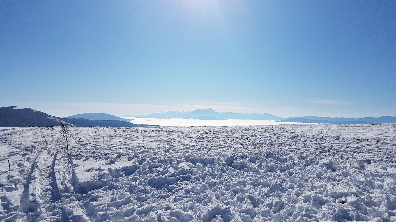 Stanic in North Macedonia - a snow covered field with mountains in the background.