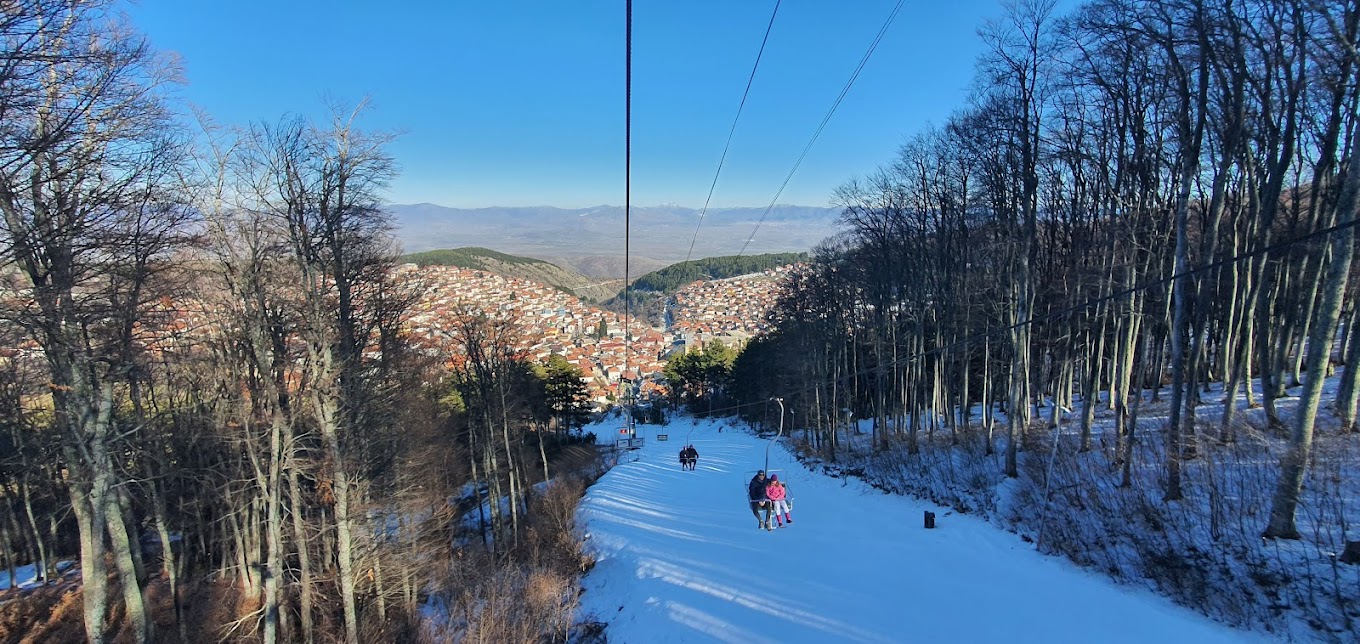 Stanic in North Macedonia - a person on a ski lift going down a hill.