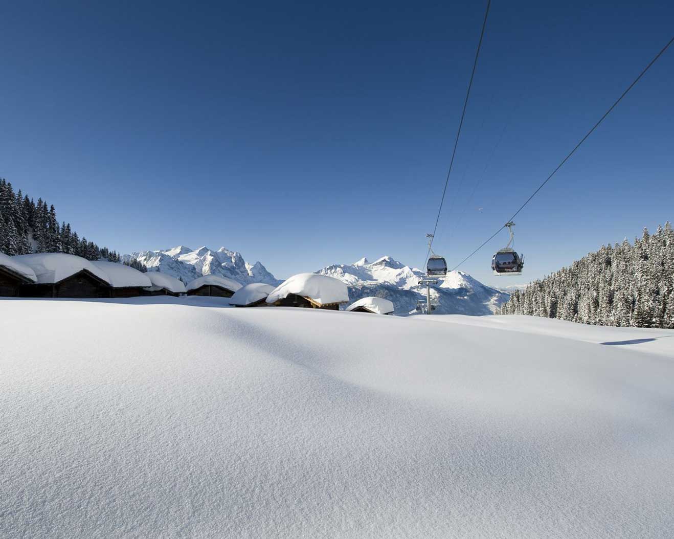 Meiringen Hasliberg in Switzerland - a ski lift going up a snowy mountain.