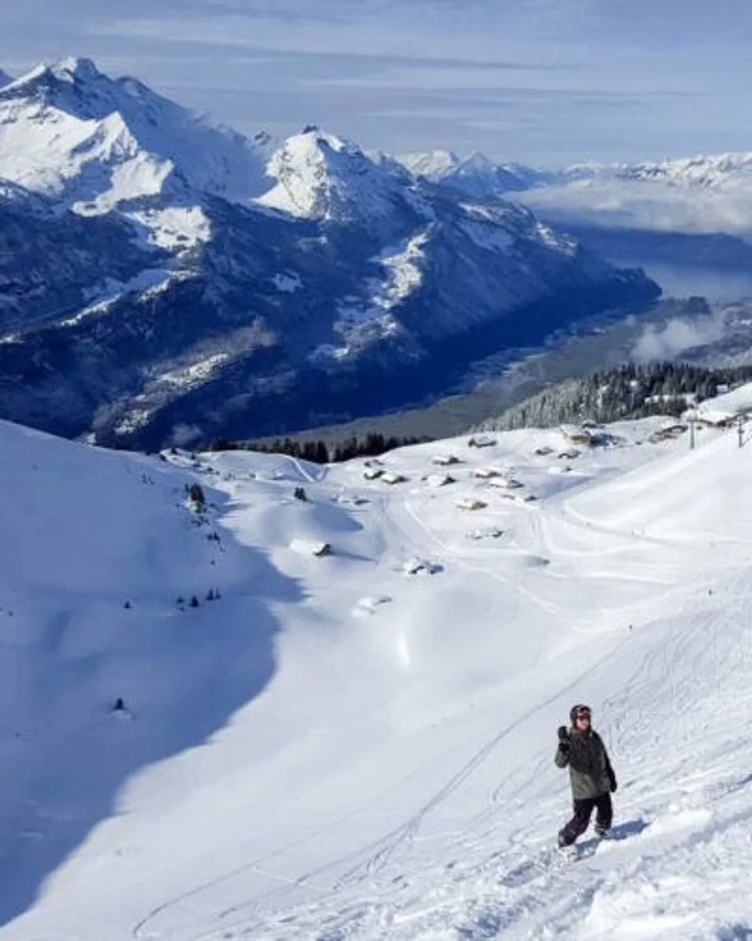 Meiringen Hasliberg in Switzerland - a person is skiing down a snowy slope.