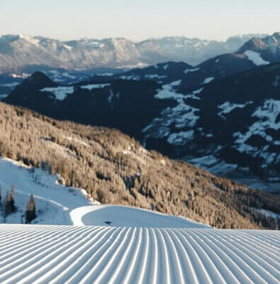 Spieljochbahn Fügen in Austria - a snow covered ski slope with mountains in the background.