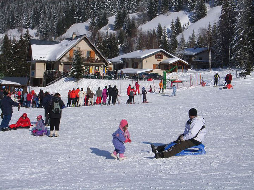 Col d'Ornon in France - a group of people that are sitting in the snow.