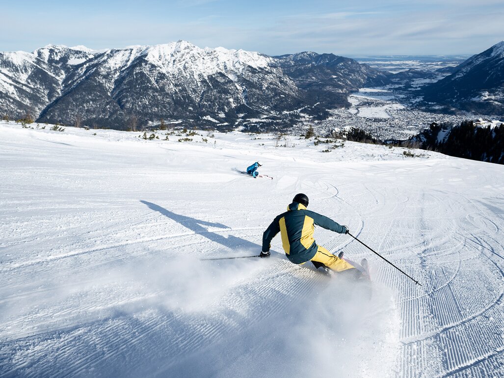 Garmisch Classic in Germany - a person skiing down a snowy slope in the mountains.