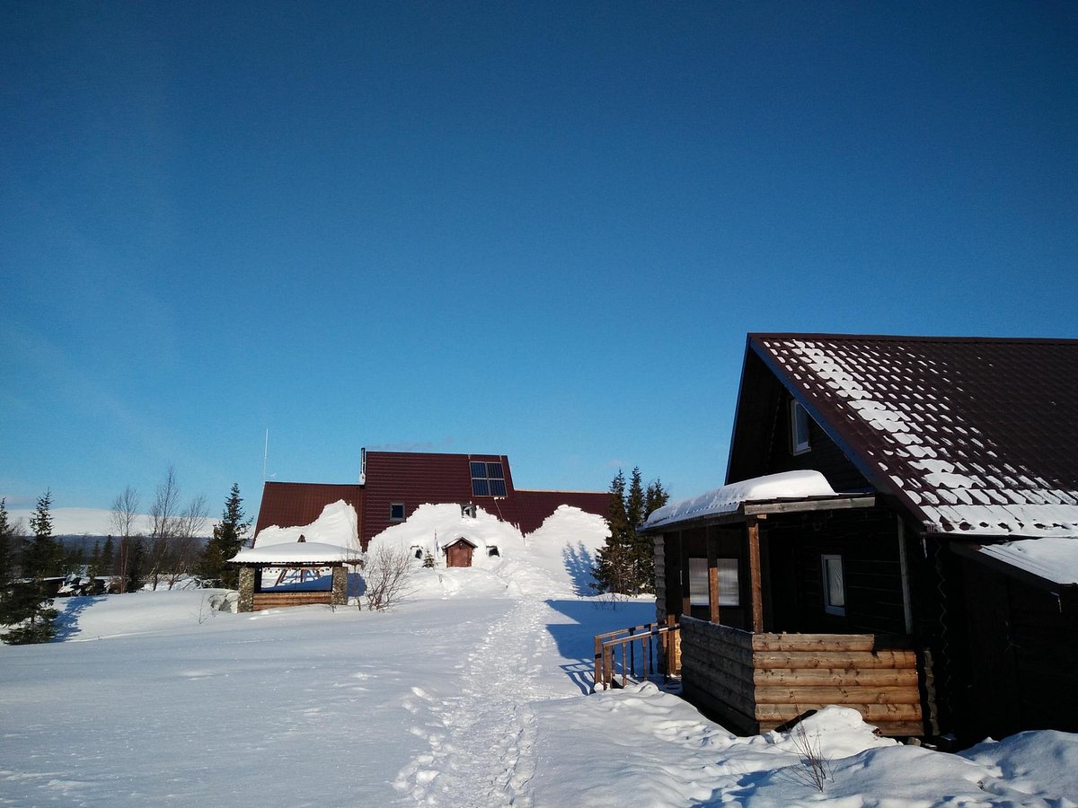 Salma in Russia - a house in the snow on a sunny day.