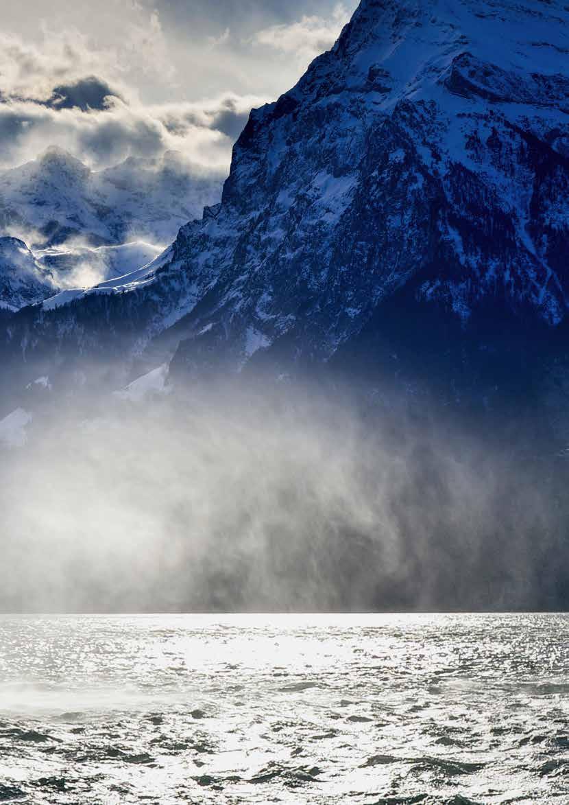 Brüsti – Attinghausen in Switzerland - a boat in the water with mountains in the background.