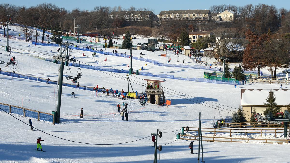 Buck Hill in USA - a ski slope with people skiing down it.