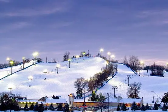View of Buck Hill ski resort in Minnesota featuring ski lifts amidst a picturesque winter landscape popular for winter sports.