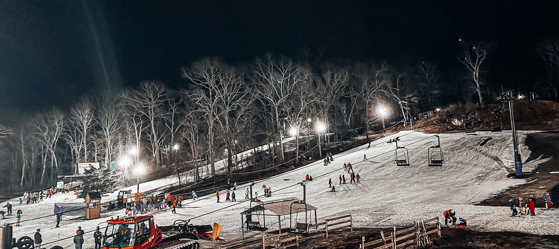 Yawgoo Valley in USA - a group of people on ski slopes at night.