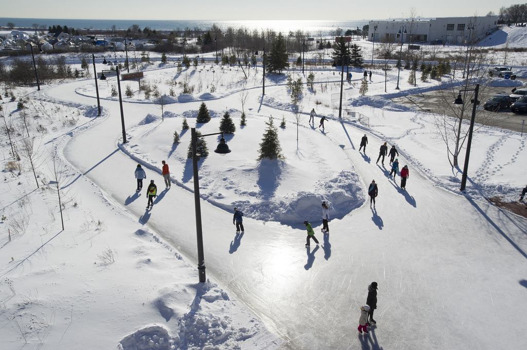 Winter scene at Earl Bales, North York in Ontario, Canada. Photo showcases a bustling winter sports scene, possibly at a ski resort. Bright, snowy landscape stuns in the background.