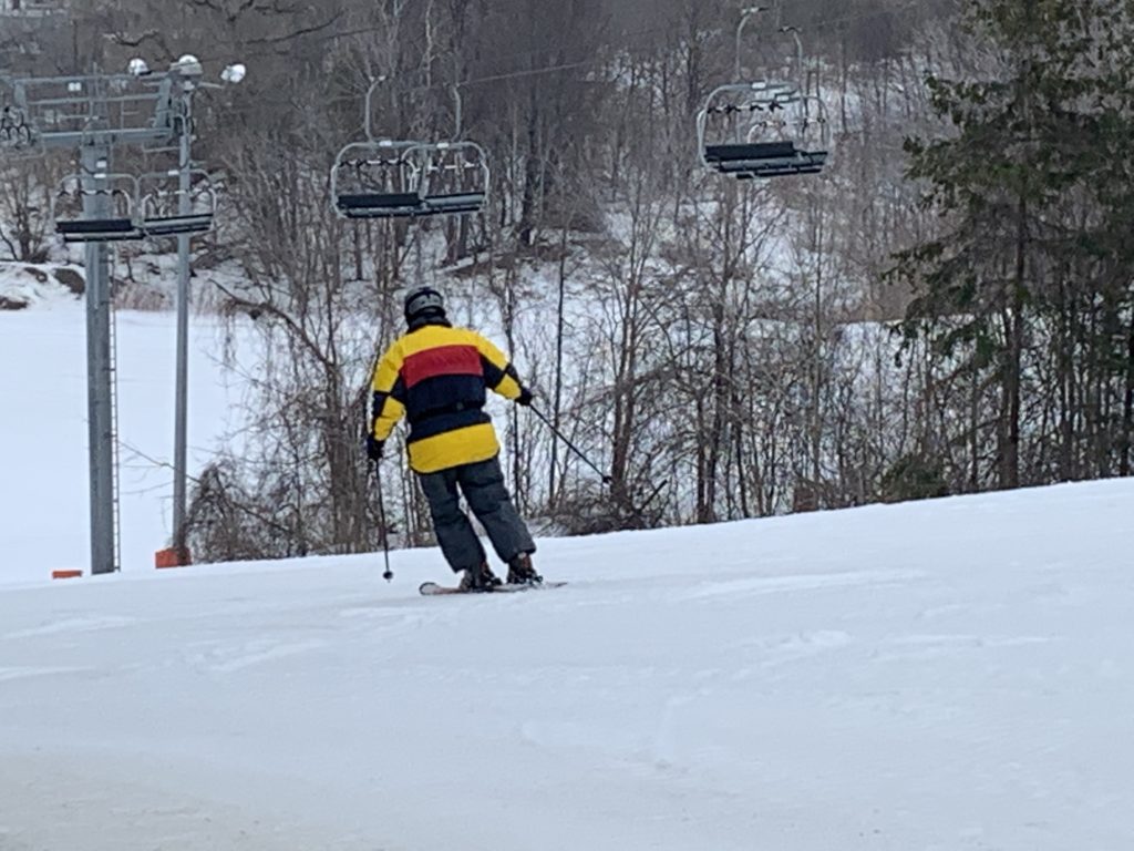 Earl Bales – North York in Canada - a person on a snowboard going down a hill.