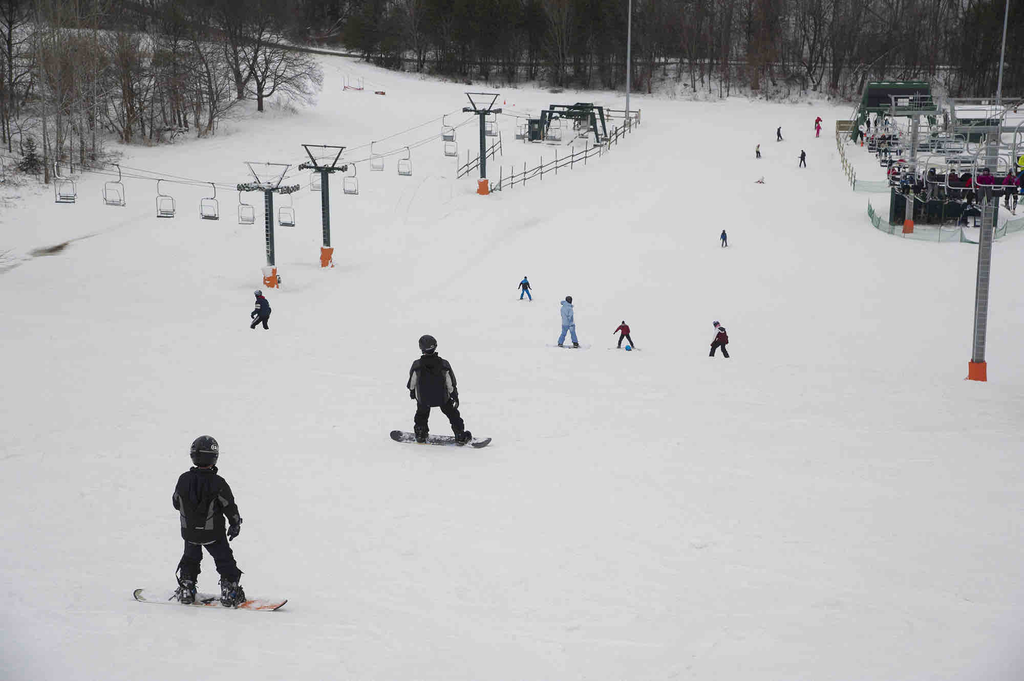 A winter sports scene at Earl Bales, North York in Ontario, Canada featuring a skier on the mountain with a ski lift nearby, at a ski resort and winter sports centre.