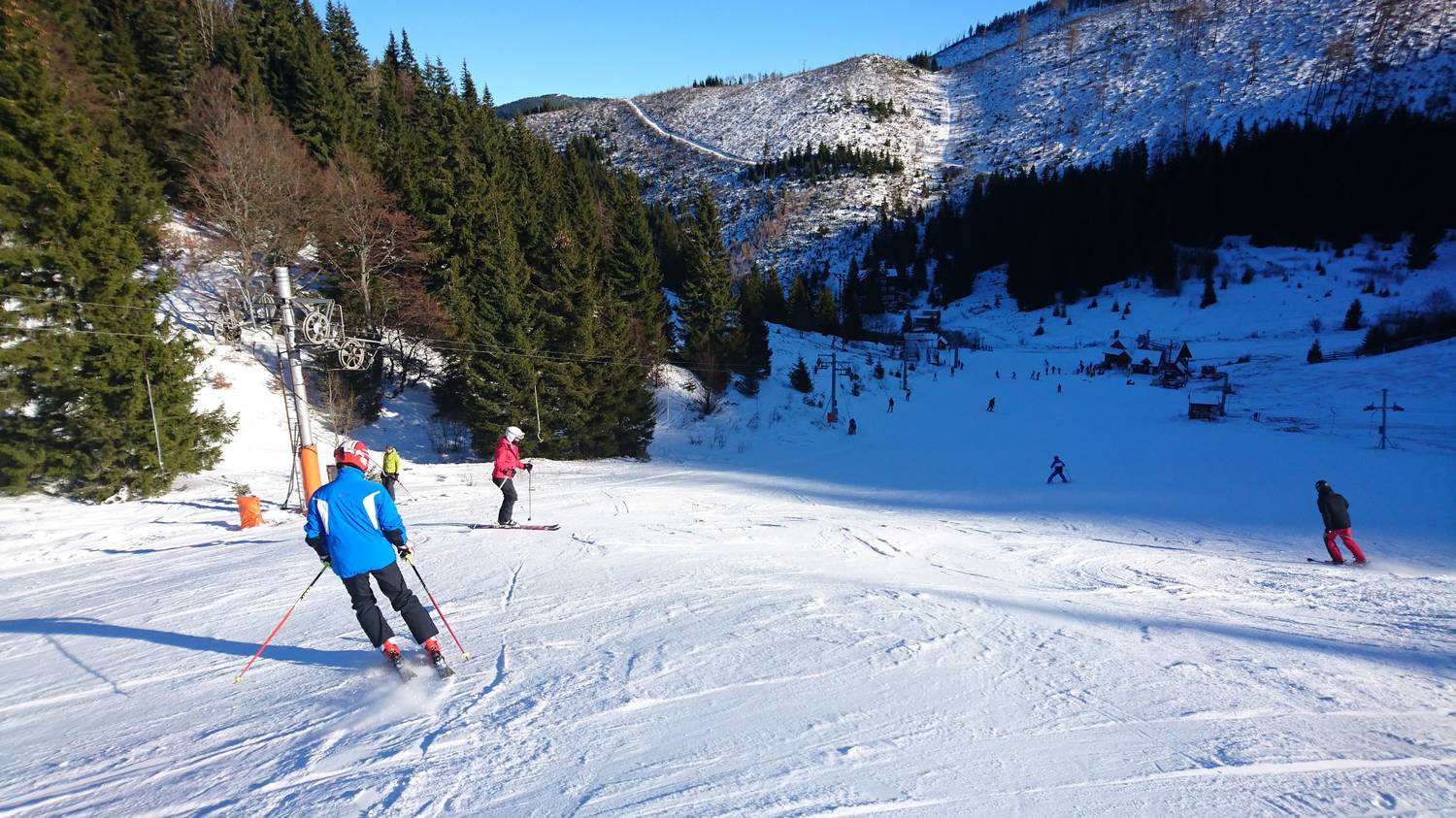 Čertovica in Slovakia - a group of people skiing down a mountain.