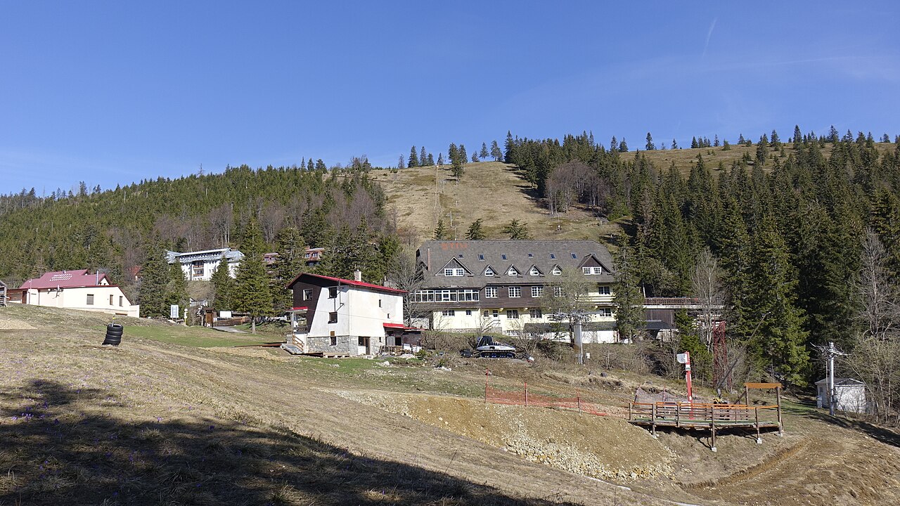 Čertovica in Slovakia - a hill with houses and trees in the background.