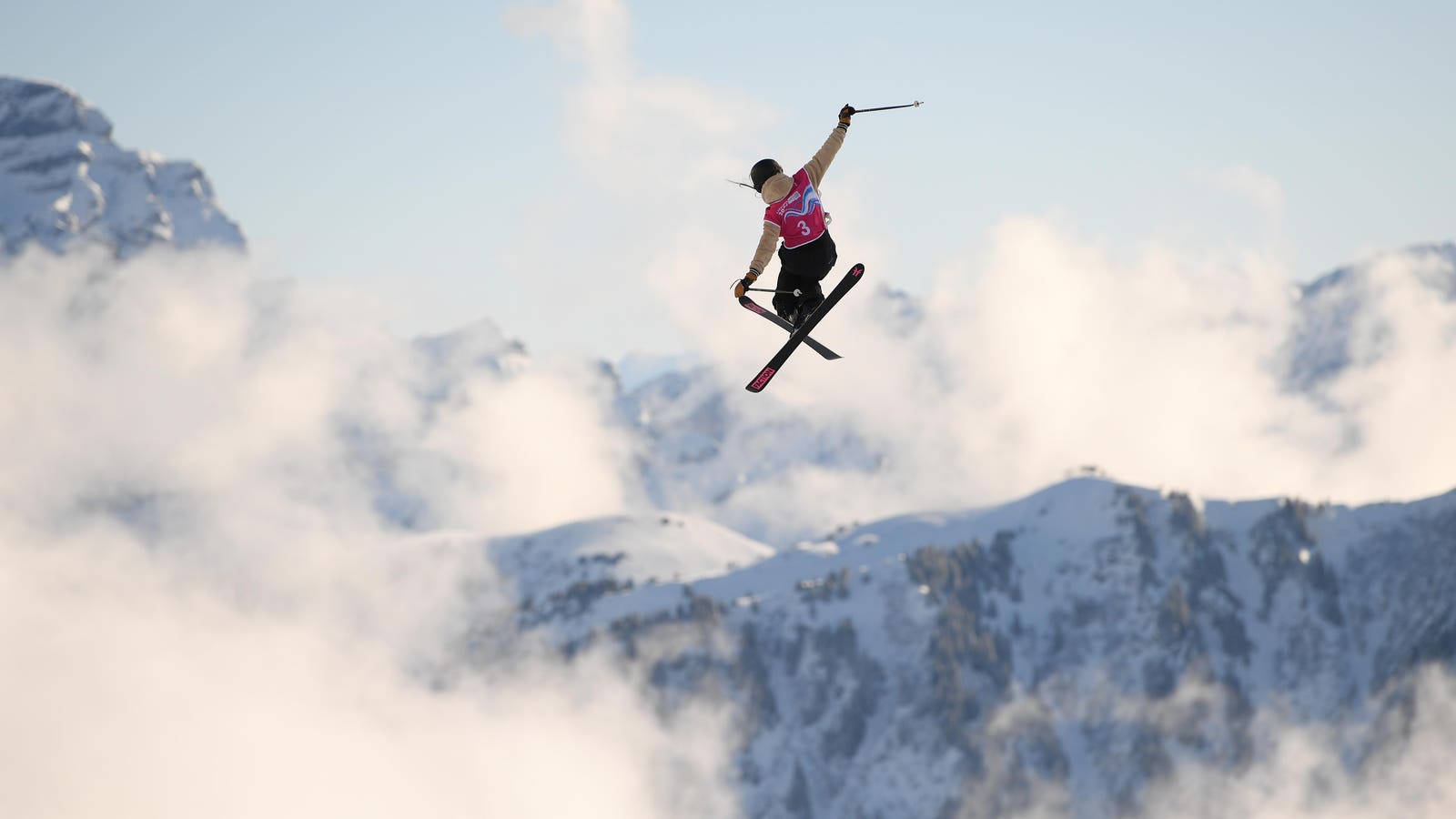 Kuutse Hill – Otepää in Estonia - a person jumping in the air with ski poles.
