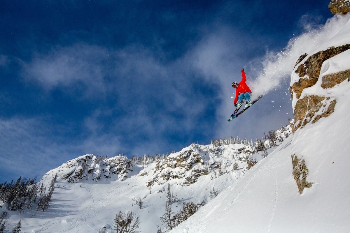 Jackson Hole in USA - a man flying through the air while riding a snowboard.