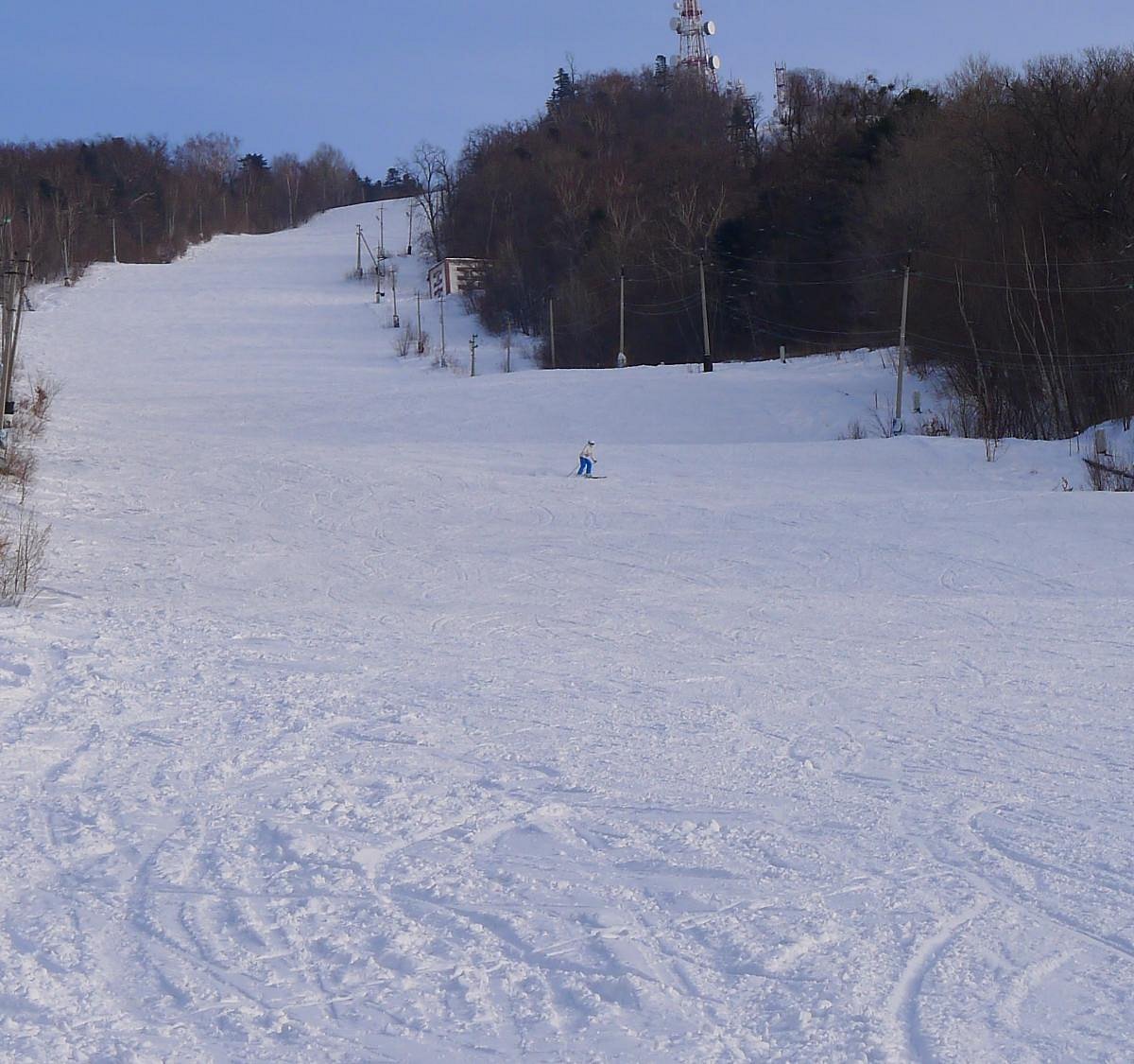 Arsgora in Russia - a person on a snowboard going down a hill.