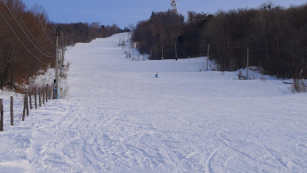 Arsgora in Russia - a ski slope with a person skiing down it.