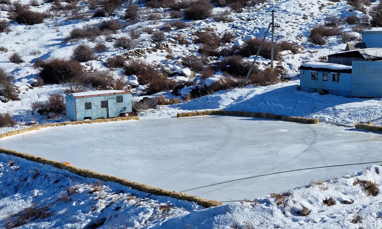 Norus in Kyrgyzstan - an ice rink in the middle of a snowy field.