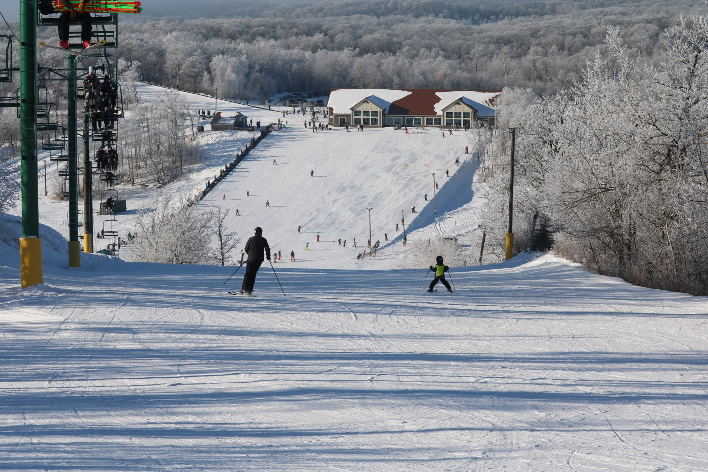 Bottineau Winter Park in USA - a group of people skiing down a snowy hill.