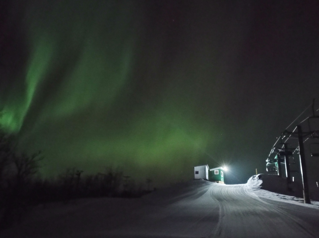 Bottineau Winter Park in USA - a car driving down a snow covered road at night.