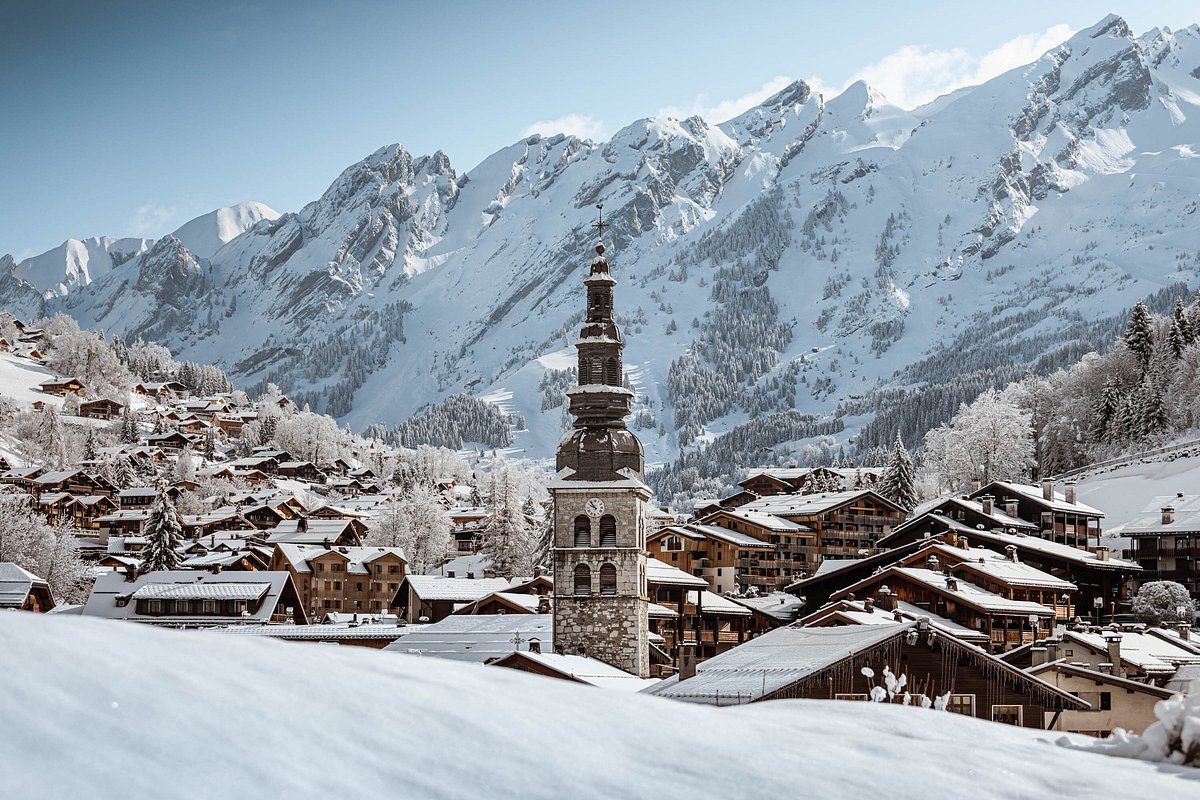 La Clusaz | Manigod in France - a snowy town with mountains in the background.