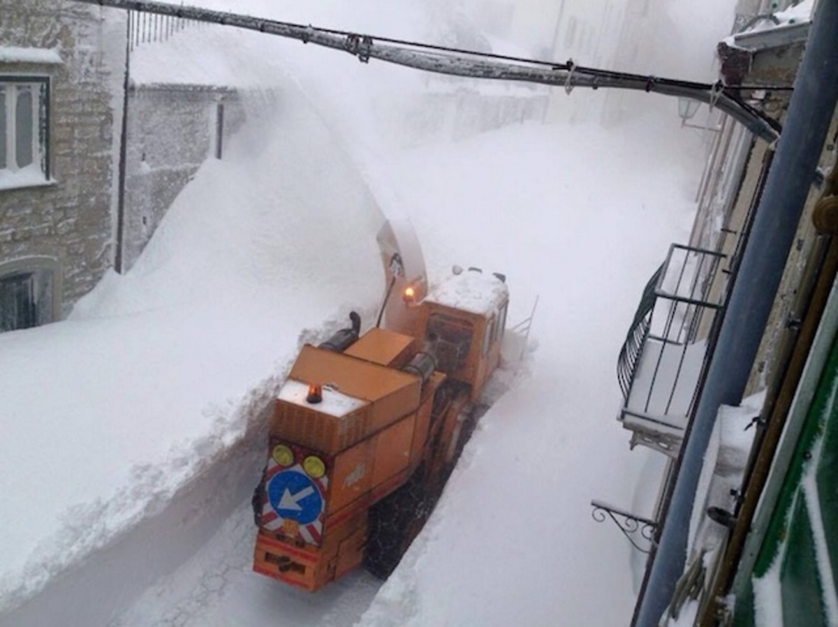 Capracotta in Italy - a snow pling machine clears snow from a street in the french city of saint - martin.