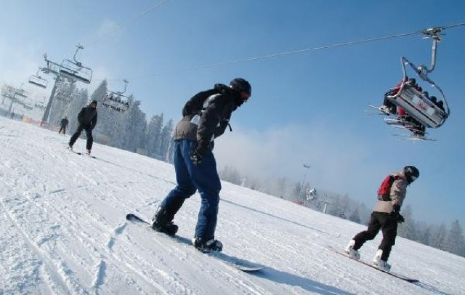 Dzikowiec – Boguszów-Gorce in Poland - a group of people skiing down a snow covered slope.