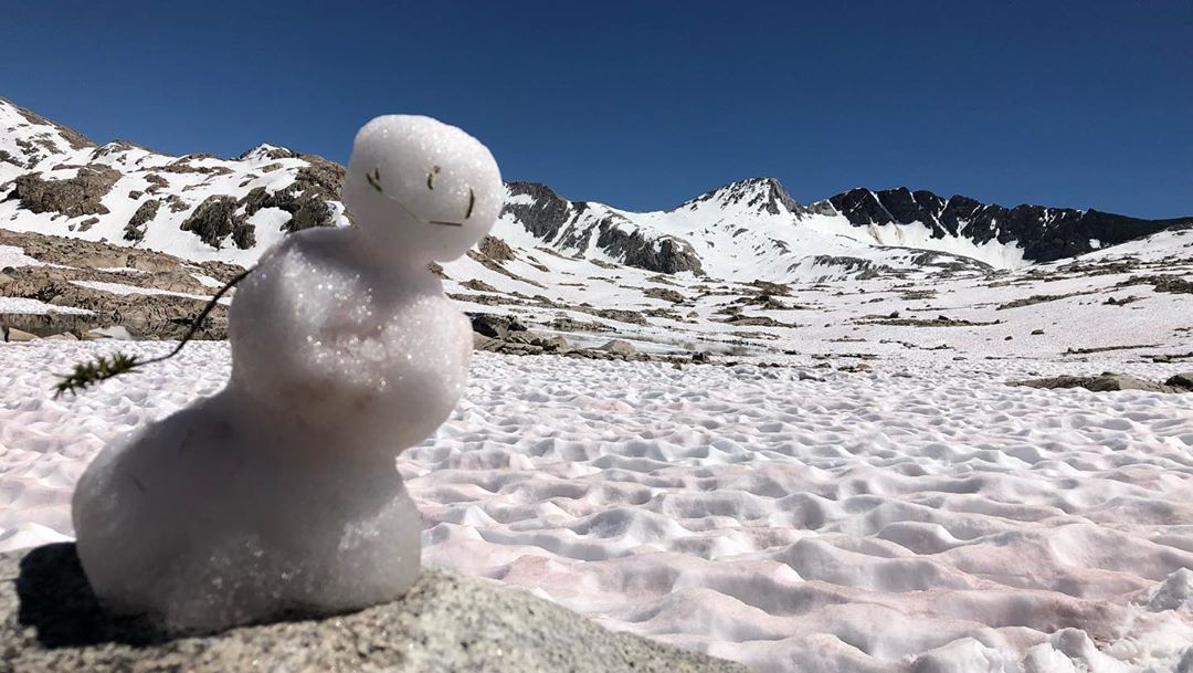 A skier descends the slope in Pradollano Sierra Nevada Spain. Lush snowy mountains loom in the background and a charming chalet completes the idyllic winter landscape.