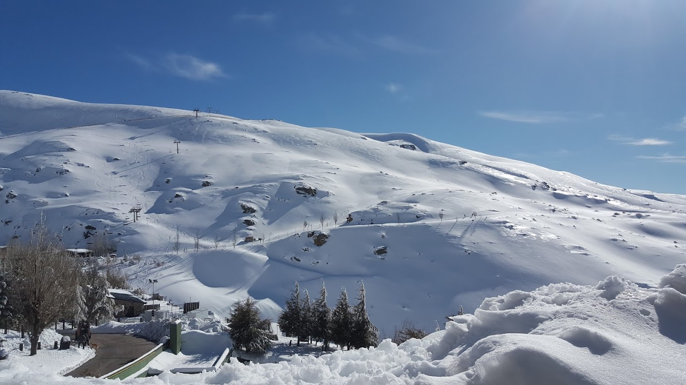 A cozy chalet nestled in Sierra Nevada-Pradollano, Granada, showcasing a bustling winter sports scene. The captivating landscape of this stunning ski resort offers a splendid winter panorama.