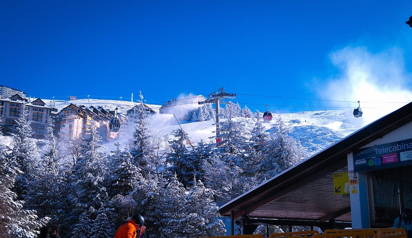Ski resort in Sierra Nevada, Pradollano, Granada showcasing stunning winter scenery, featuring active winter sports scene and a ski lift.