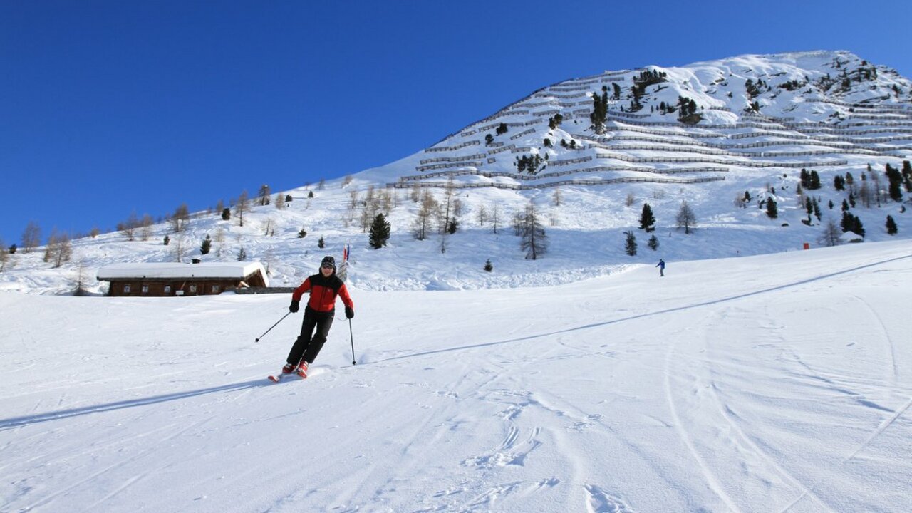 Pfelders in Italy - a person skiing down a snow covered mountain.