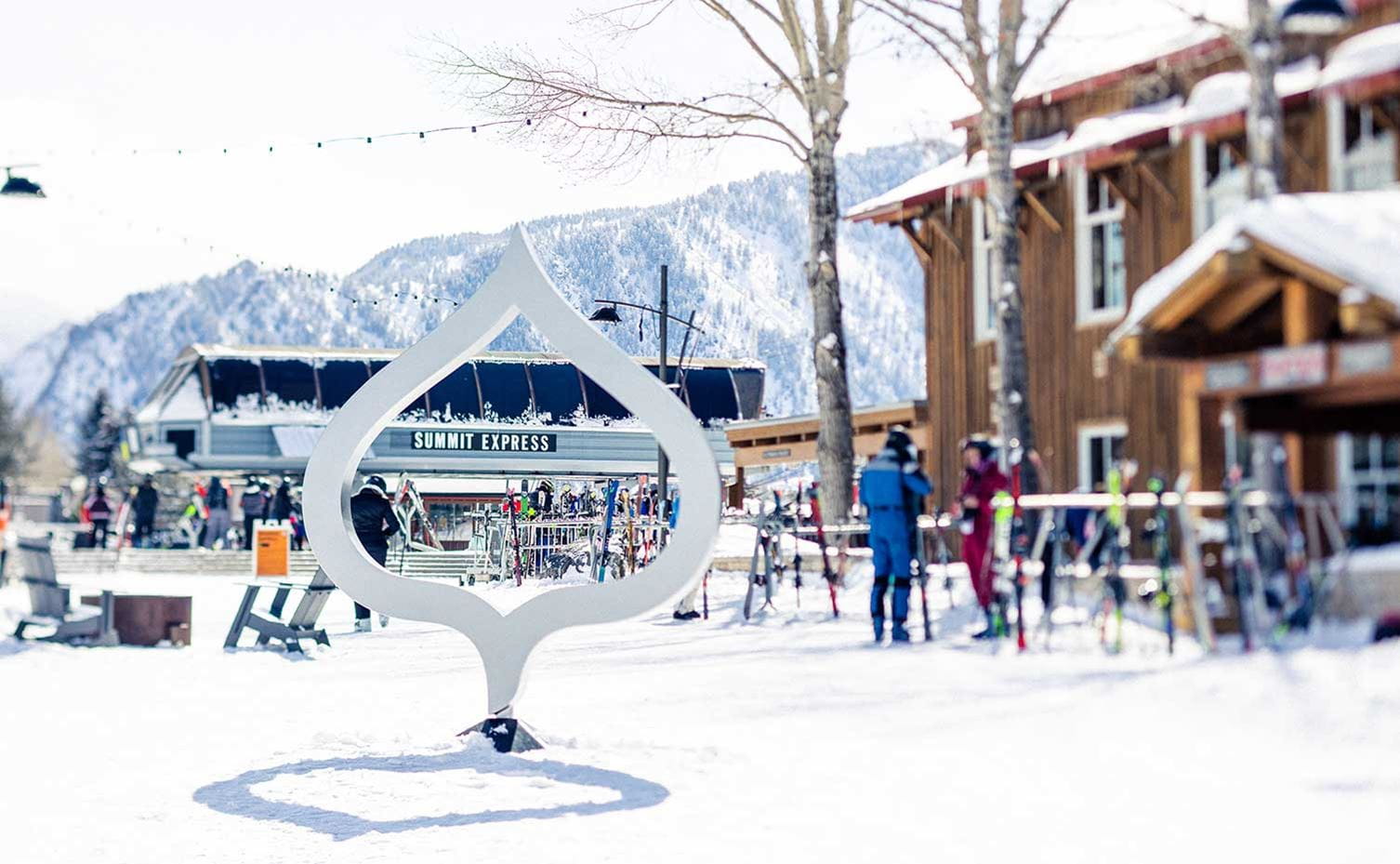 Buttermilk Mountain in USA - a group of people standing around a sign in the snow.