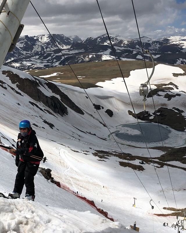 Beartooth Basin in USA - a man standing on top of a snow covered mountain.
