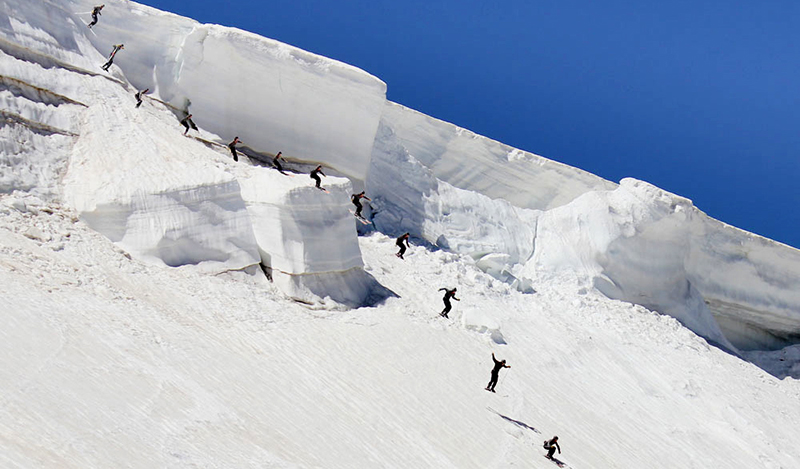 Beartooth Basin in USA - a group of people skiing down a snow covered mountain.