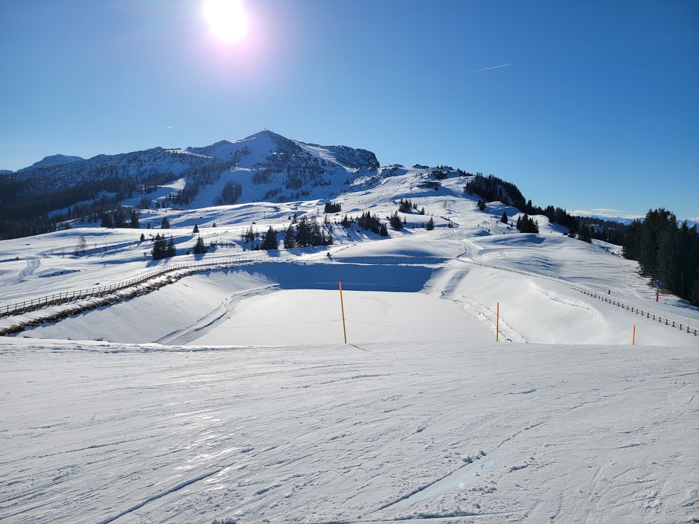 Winklmoos-Steinplatte in Austria - the sun is shining over the snow covered mountains.