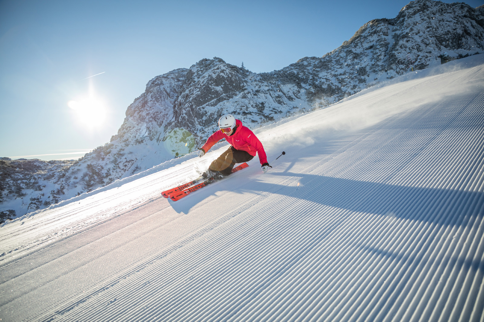 Winklmoos-Steinplatte in Austria - a person riding a snowboard down a snowy slope.