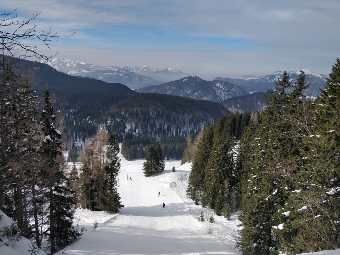 Winklmoos-Steinplatte in Austria - a person skiing down a snowy slope in the mountains.