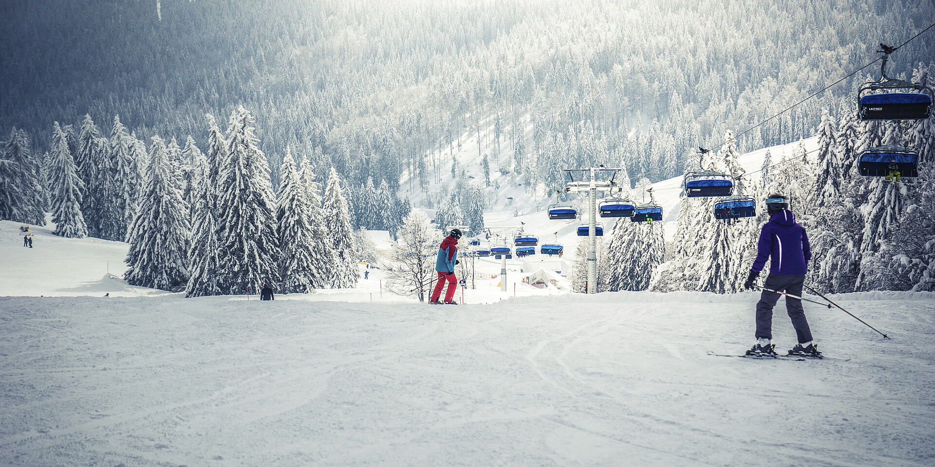 Muggenbrunn in Germany - a group of people skiing down a snowy slope.