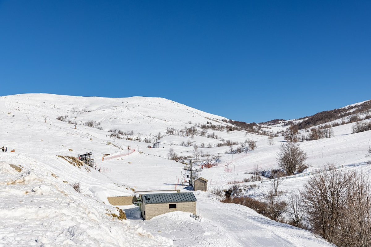 Val d'Ese in France - a snow covered mountain with a small house on top.