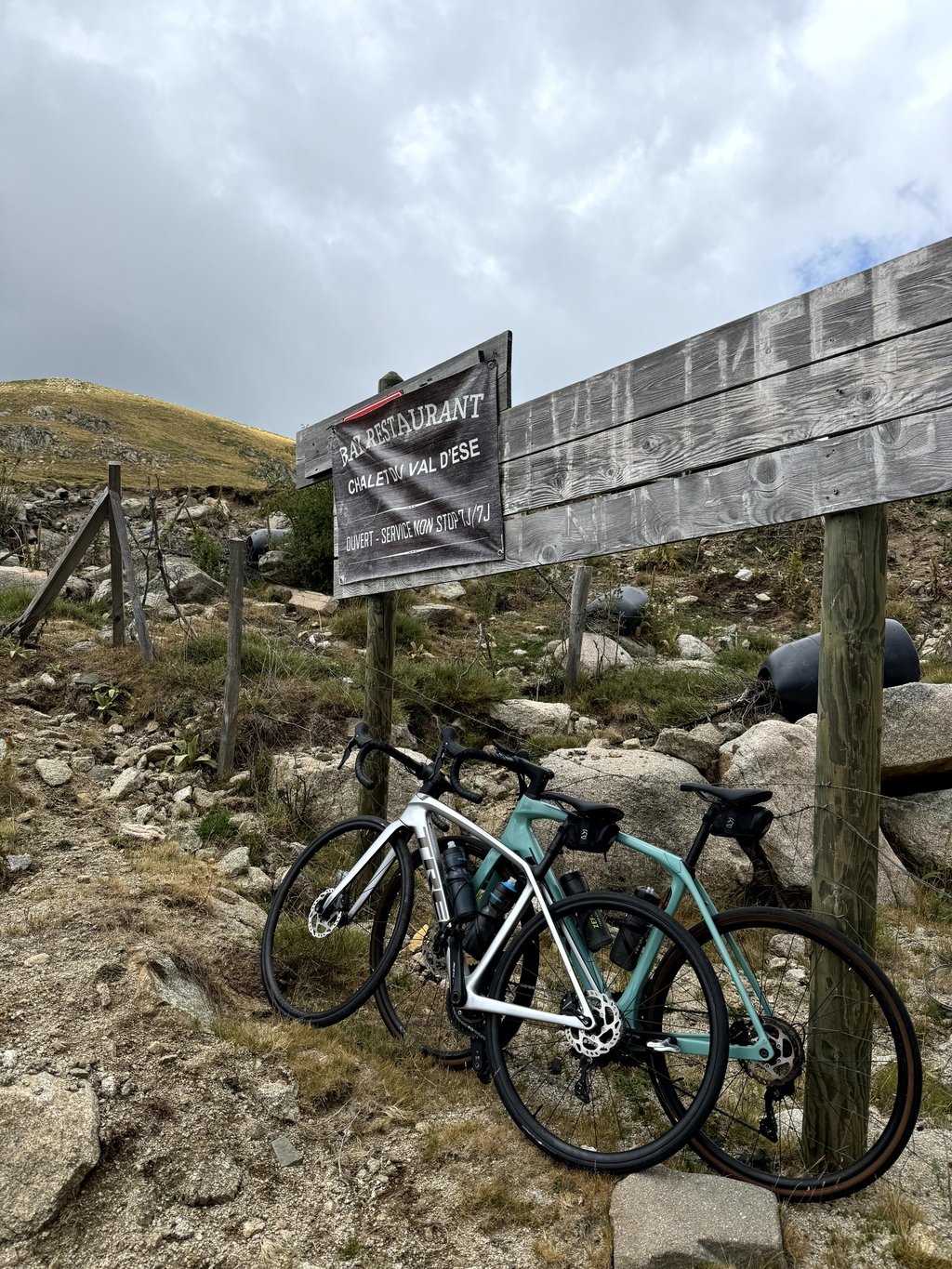 Val d'Ese in France - a bike parked next to a sign on a mountain.