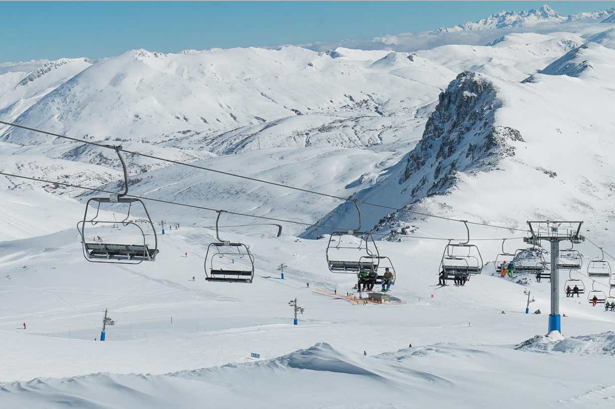 San Isidro-Zona Salencias in Spain - a ski lift going up a snowy mountain.