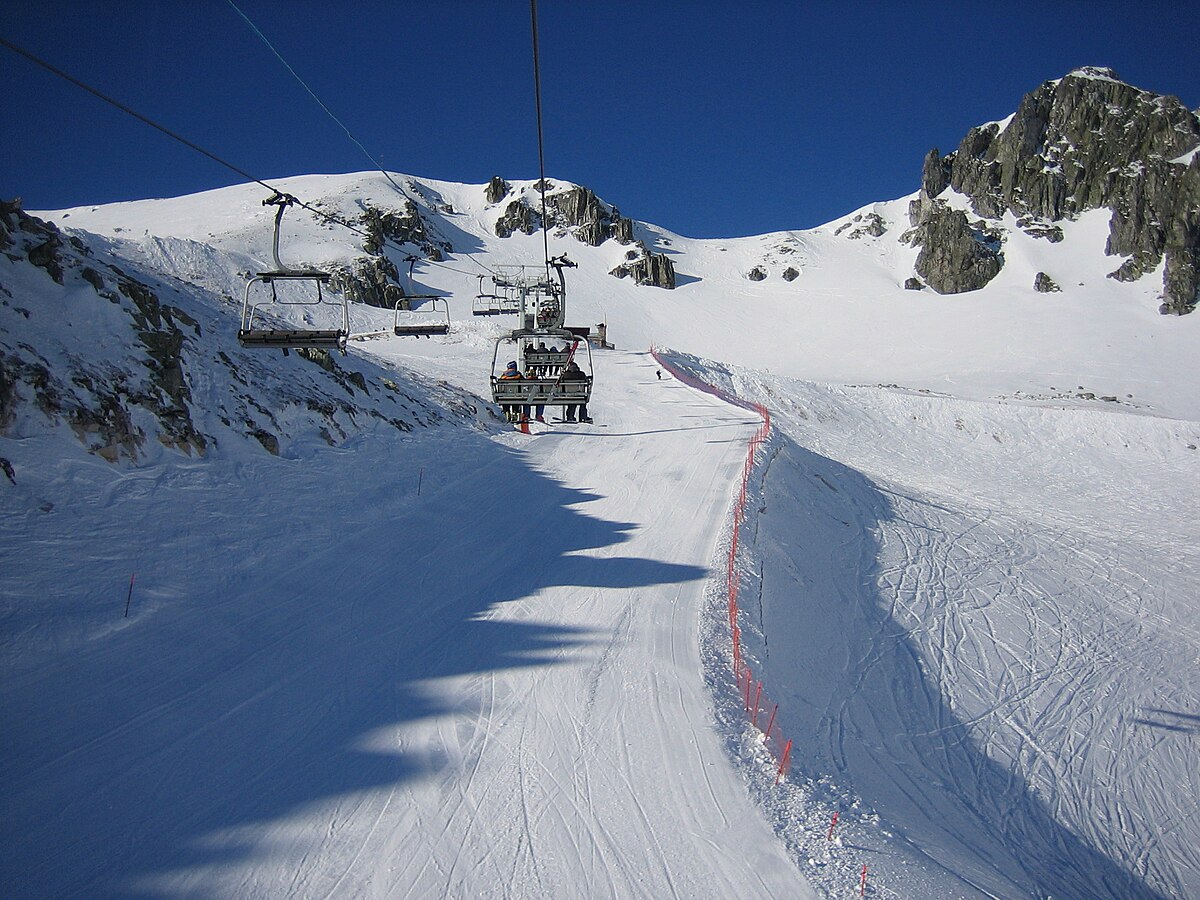 San Isidro-Zona Salencias in Spain - a ski lift going down a snowy slope.