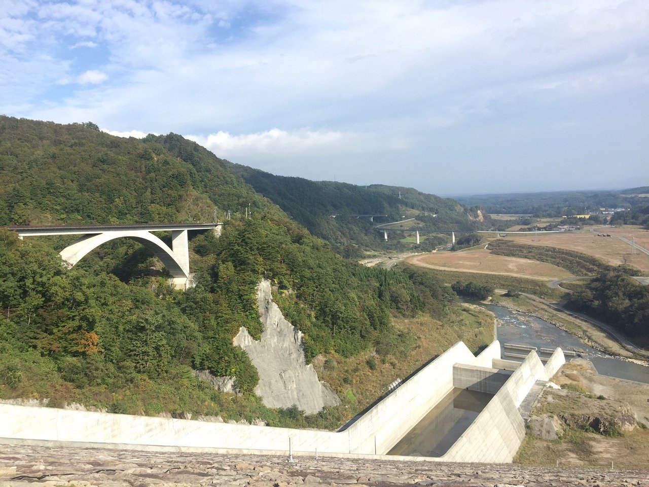 Fujisato Choei in Japan - a bridge over a river in the middle of a valley.